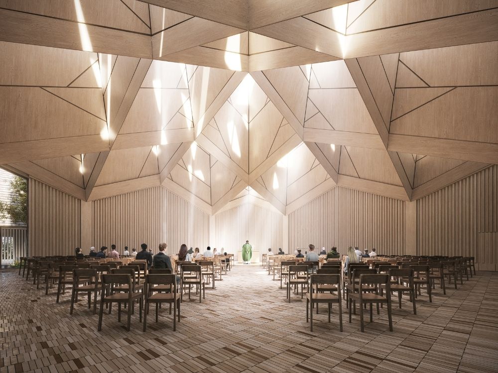A modern church with a geometric wooden ceiling, filled with natural light.