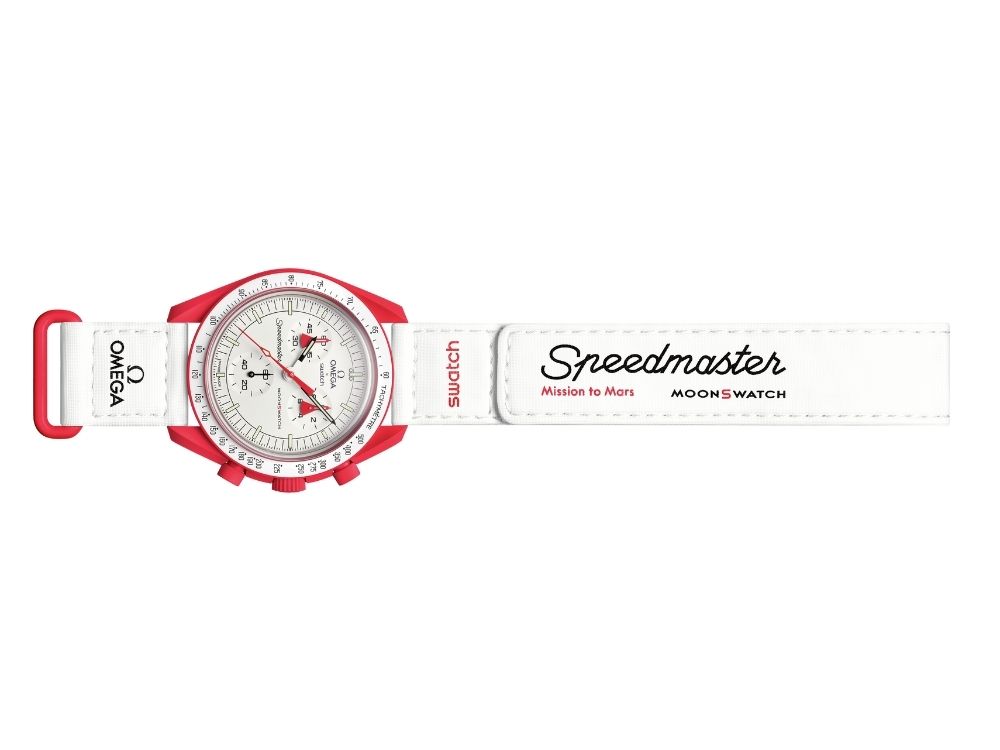 White and red Omega x Swatch Speedmaster "Mission to Mars" watch. It features a red case, white dial, and a white strap with branding text.