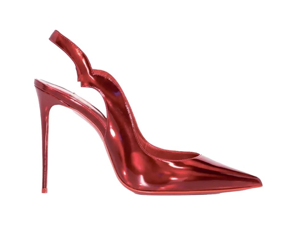A shiny, red stiletto heel with a pointed toe and slingback strap. The design is sleek and elegant, conveying a sense of glamour and sophistication.